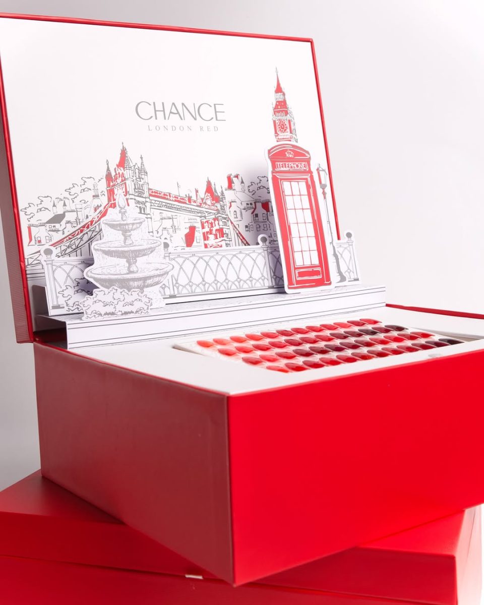 Open Chance "London Red" 48-color professional gel polish set display box, featuring a detailed 3D pop-up illustration of classic London landmarks like the Red Telephone Box and Big Ben. The deep red collection box holds the 48-shade swatch board, showing the comprehensive range of reds from bright scarlet to deep wine, ideal for iconic manicures. Chance Creation Collections.