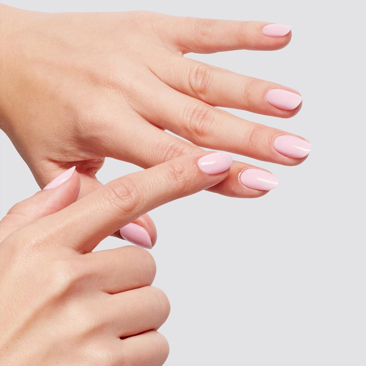 Applying the OPI Nature Strong Glow Up Nail & Cuticle Oil on nails