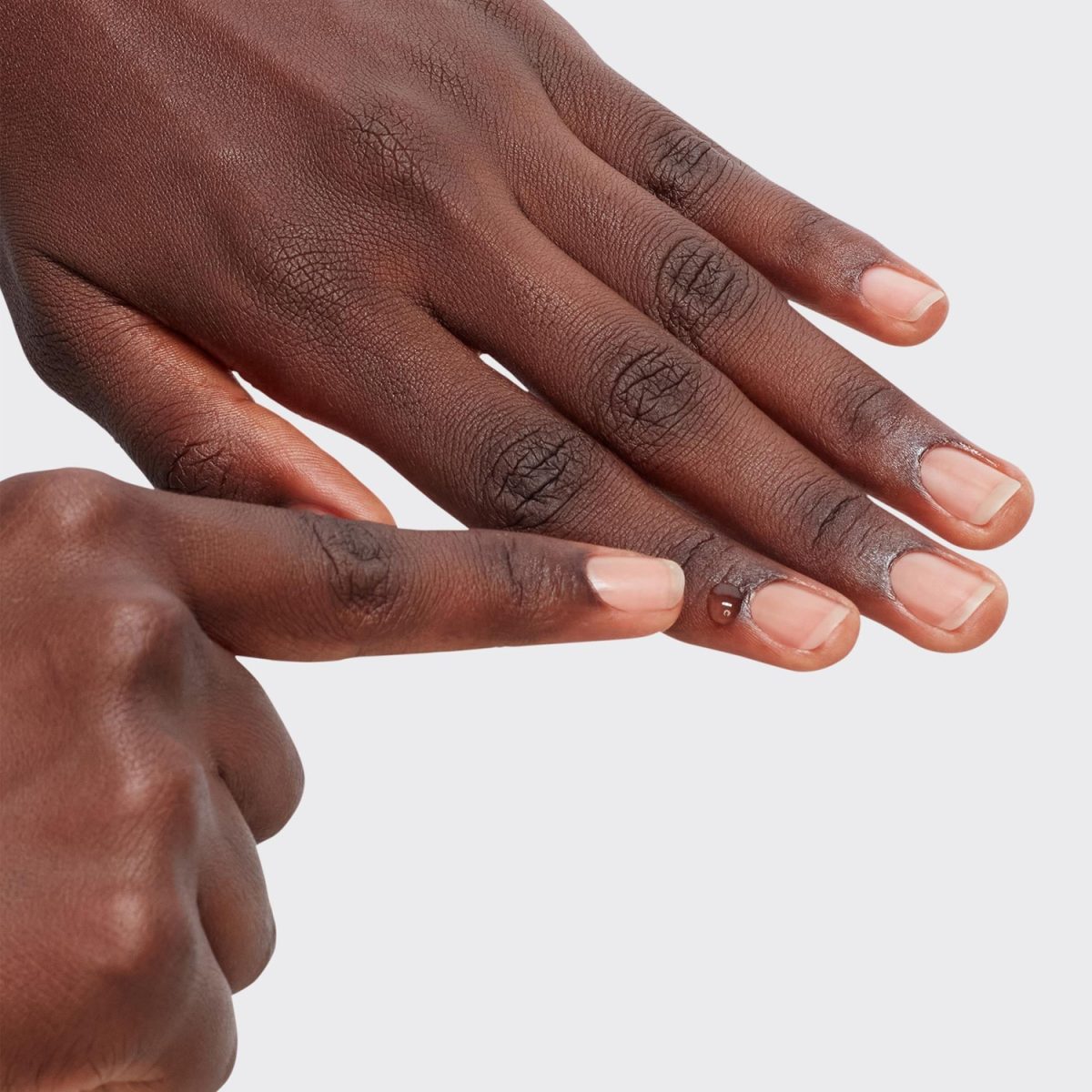 Applying the OPI Nature Strong Soothe & Remove Cuticles on nails