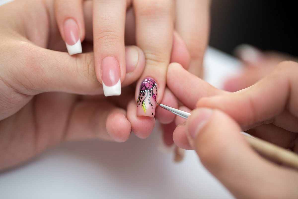 Closeup shot man making manicure to woman in beauty salon. Nail Art or Finish.