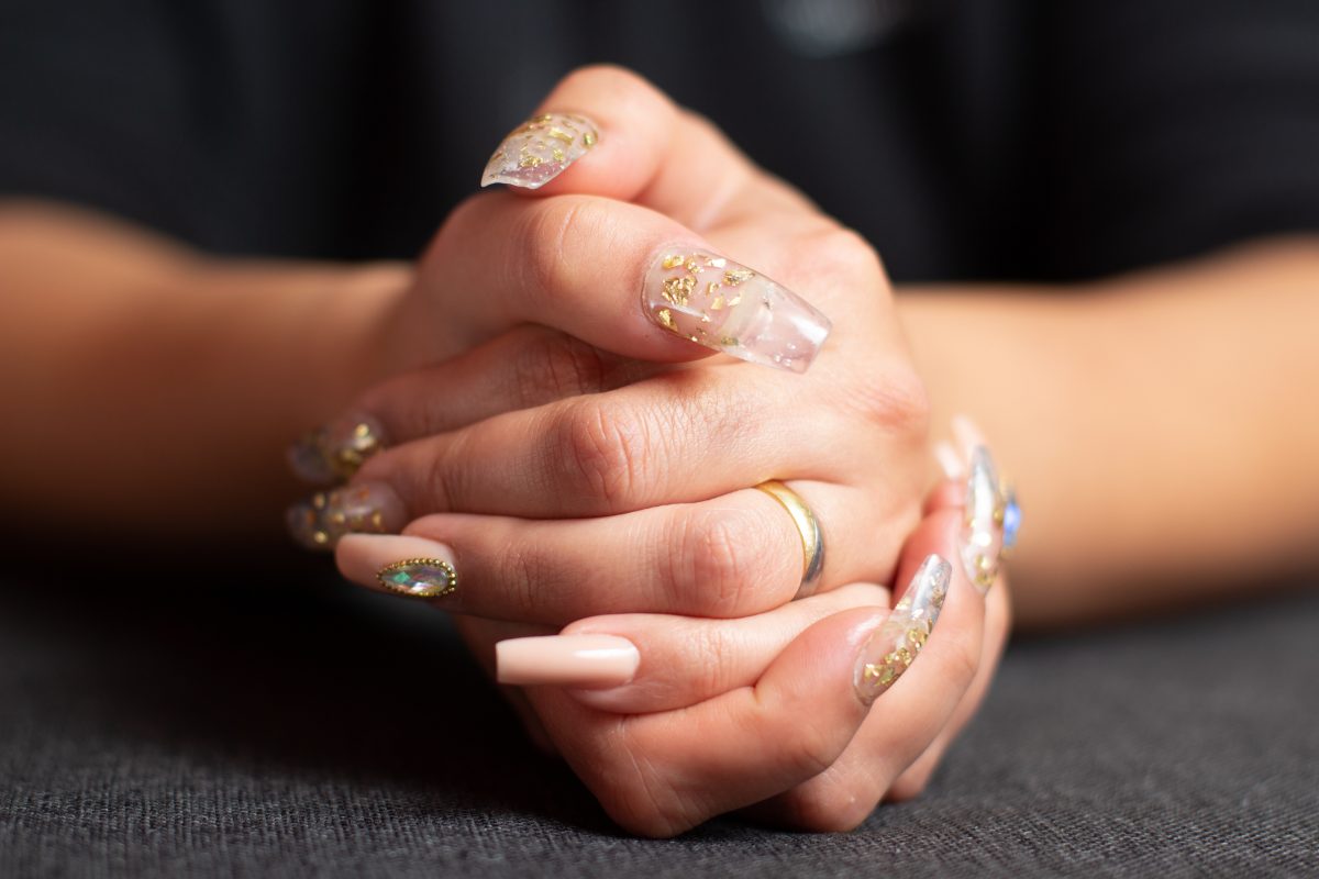 A closeup shot of female hands with trendy glossy manicure on her nails.
