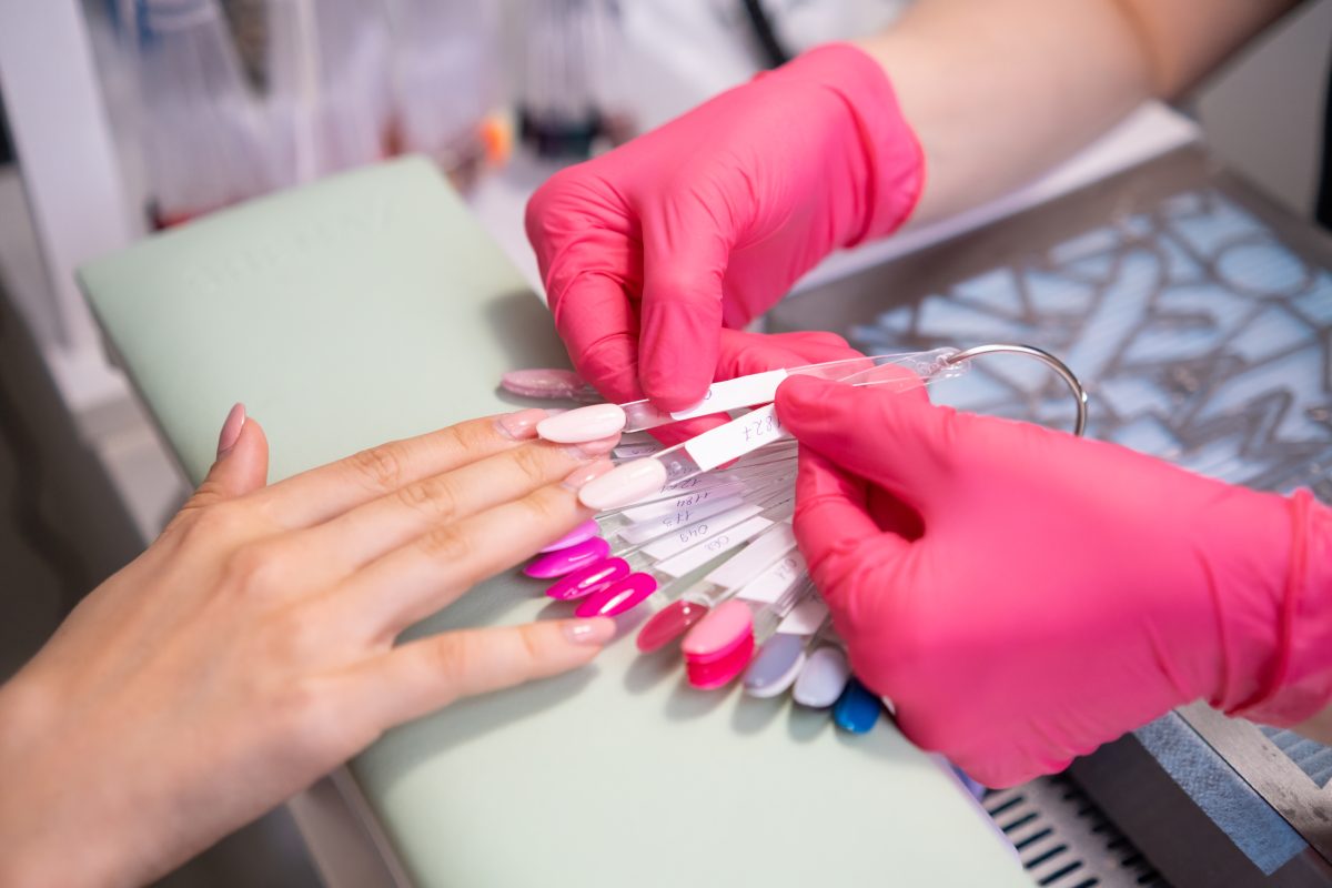 Nail master helps to select a nails color polish from the samples collection. A palette of transparent tips with different colors. Top Acrylic Nail Shapes for 2025
