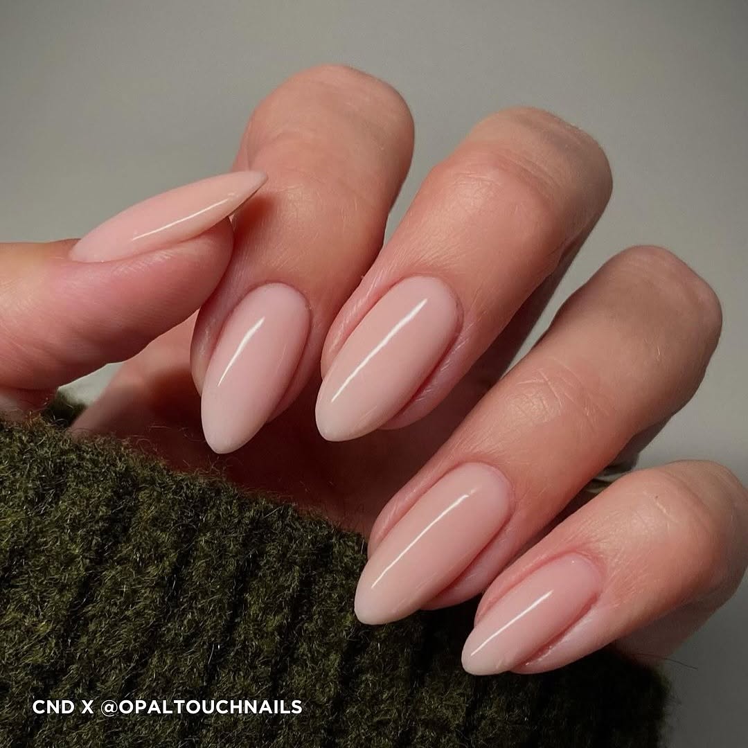 Detailed view of almond-shaped gel nails with a soft pink nude CND Plexigel overlay. Elegant, clean aesthetic manicure perfect for everyday wear or bridal nail inspiration. CND PLEXIGEL Application