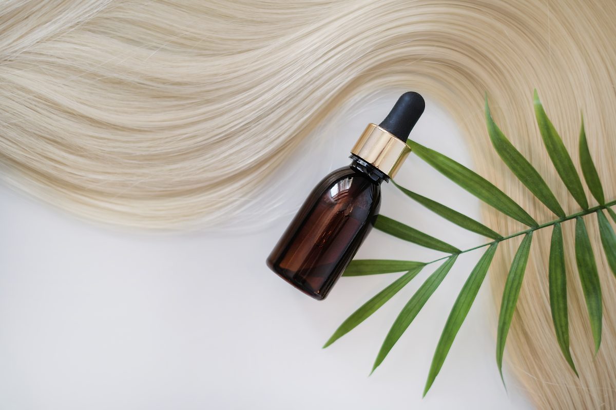 Close-up oil bottle and recovery hair. Concept hairdresser spa salon. hair restoration and treatment after winter.