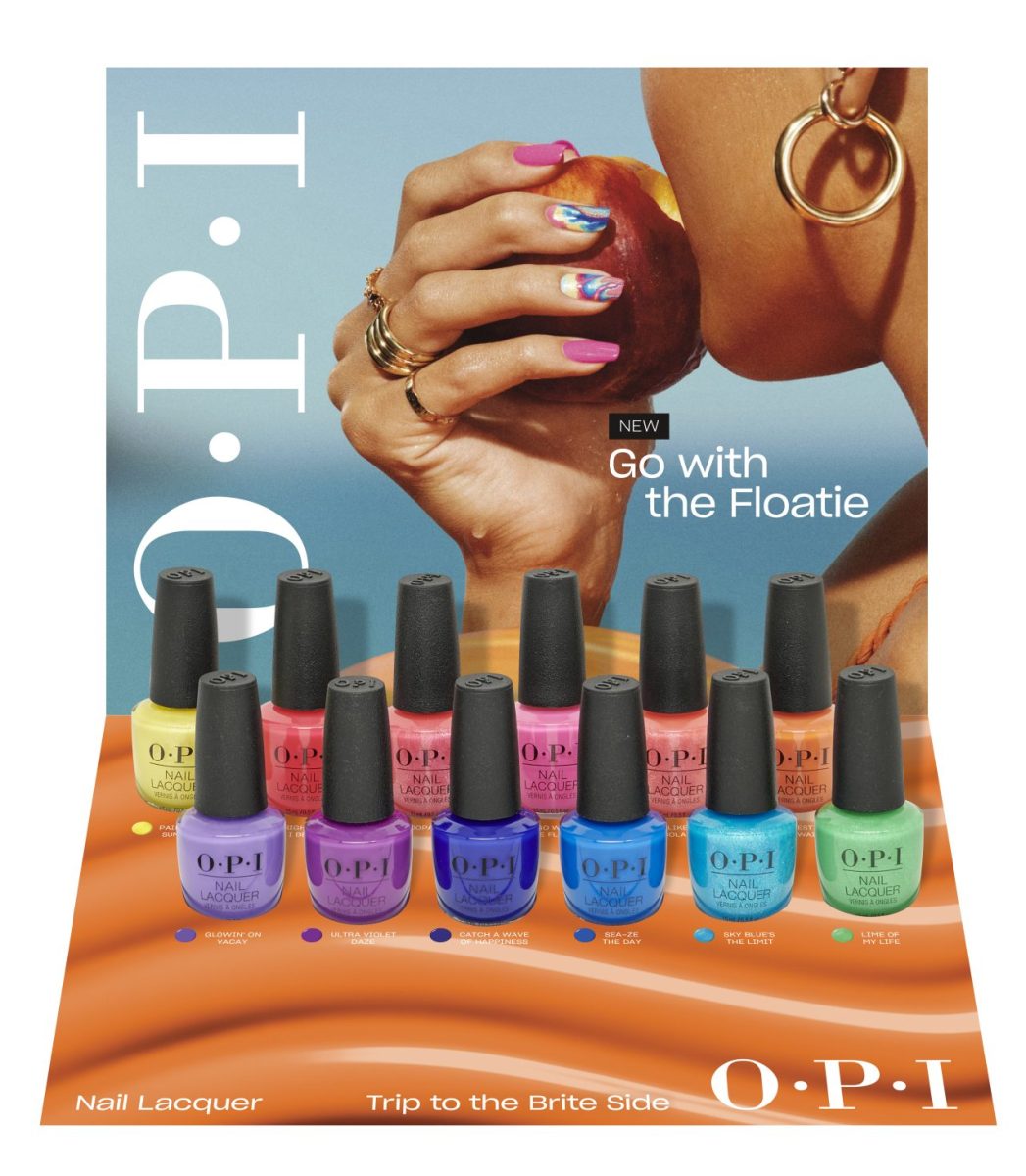 The full collection of OPI Infinite Shine nail polishes and sheer glaze toppers arranged on coastal rocks by the sea for salon color selection.