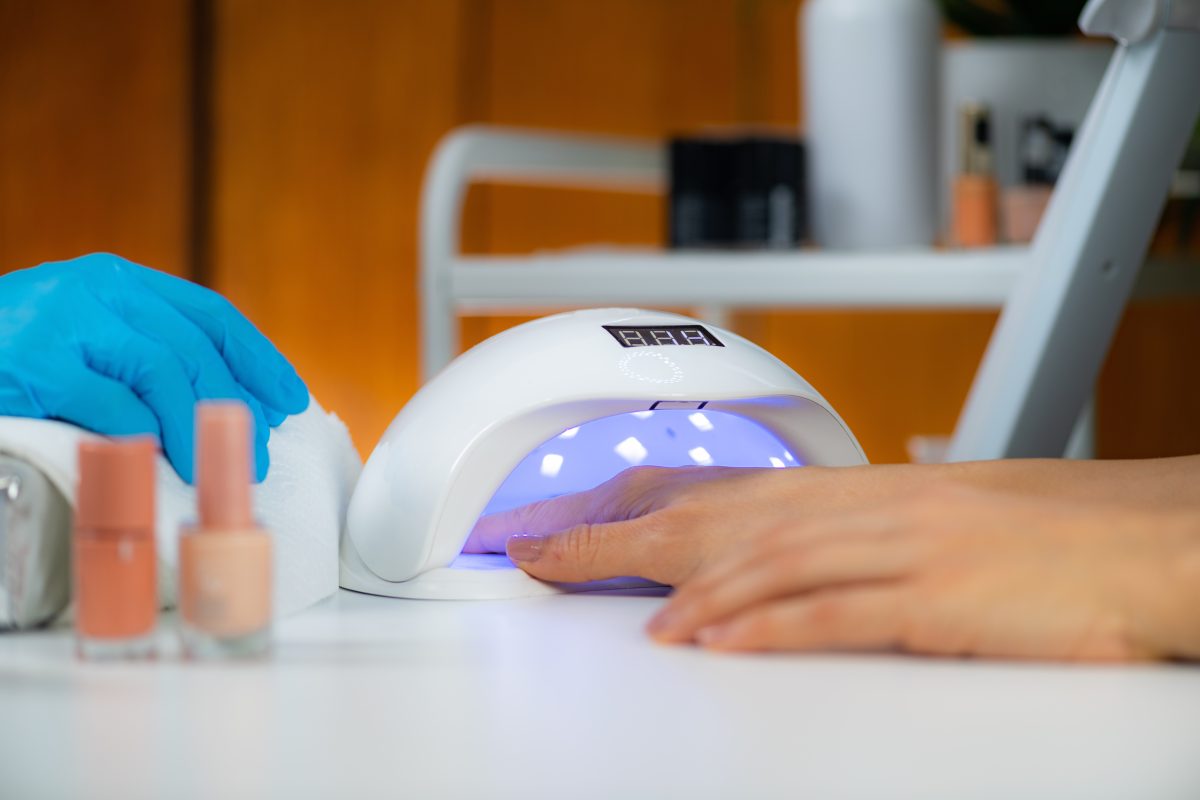 UV Lamp for Nails. Manicure Treatment in Beauty Salon