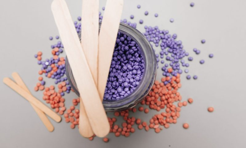 Pink and lilac hard wax granules.